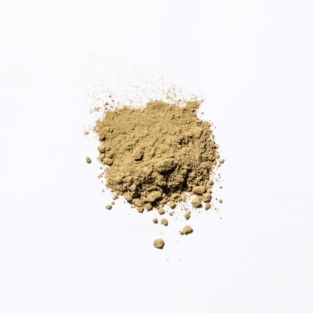 dried kava root powder on white background